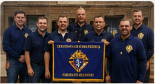 Knights posing with the council banner